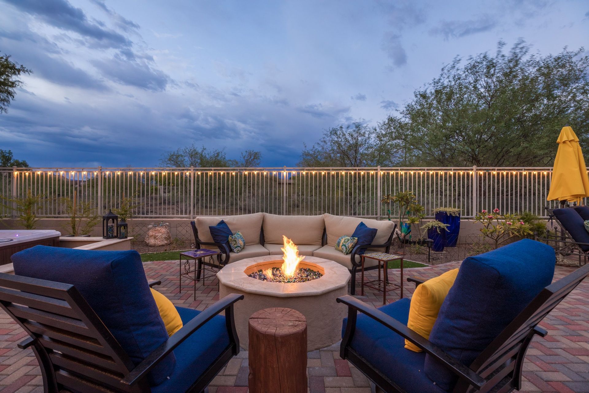 There is a fire pit in the middle of the patio.