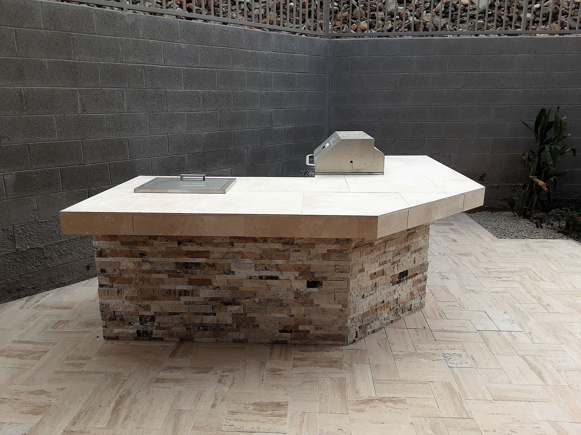 A stone table with a grill on top of it
