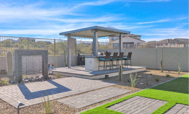 There is a gazebo in the middle of the backyard.