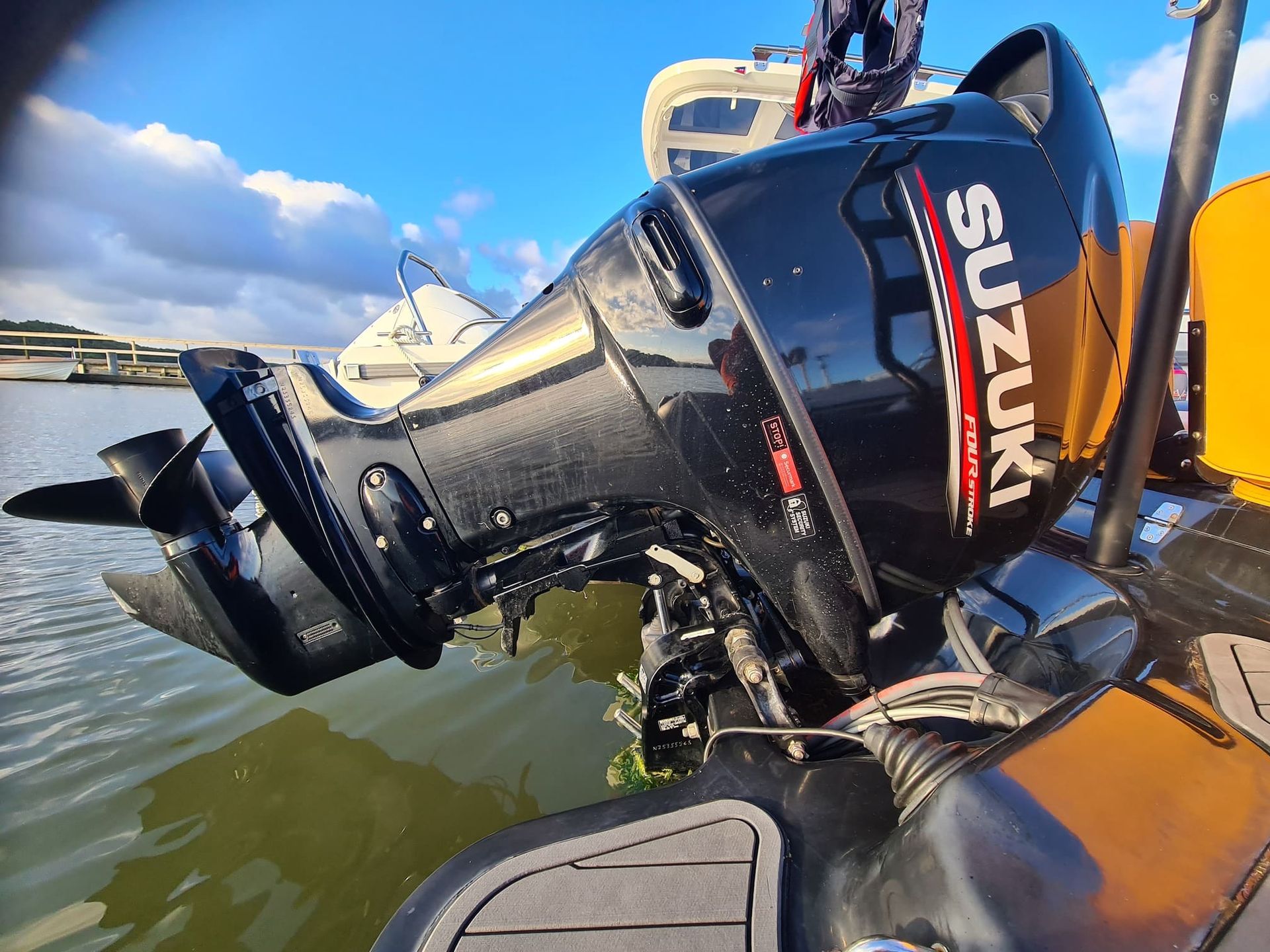 A suzuki outboard motor is sitting on top of a boat.