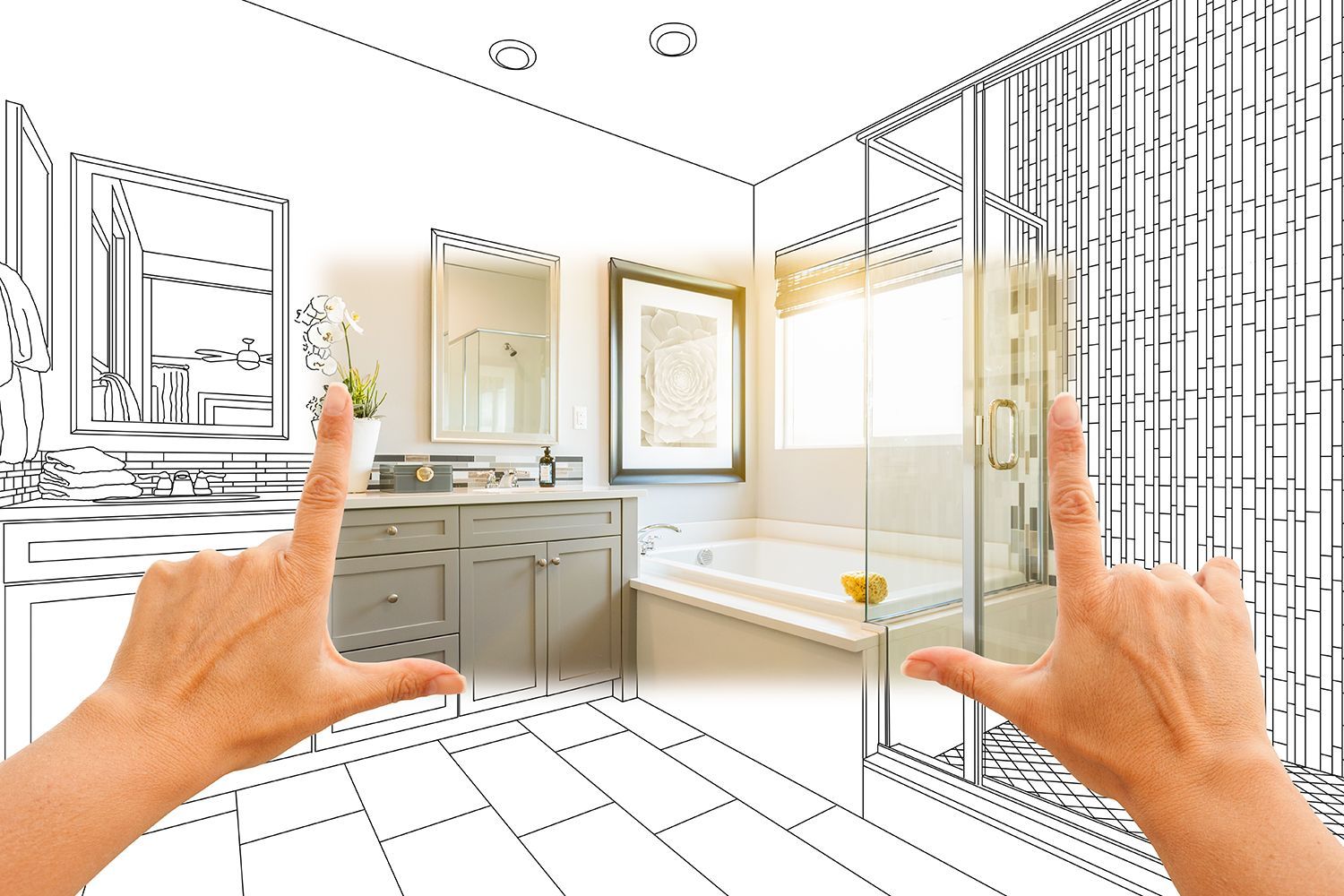 Hands framing a bathroom remodel concept blending a sketch with a finished design.