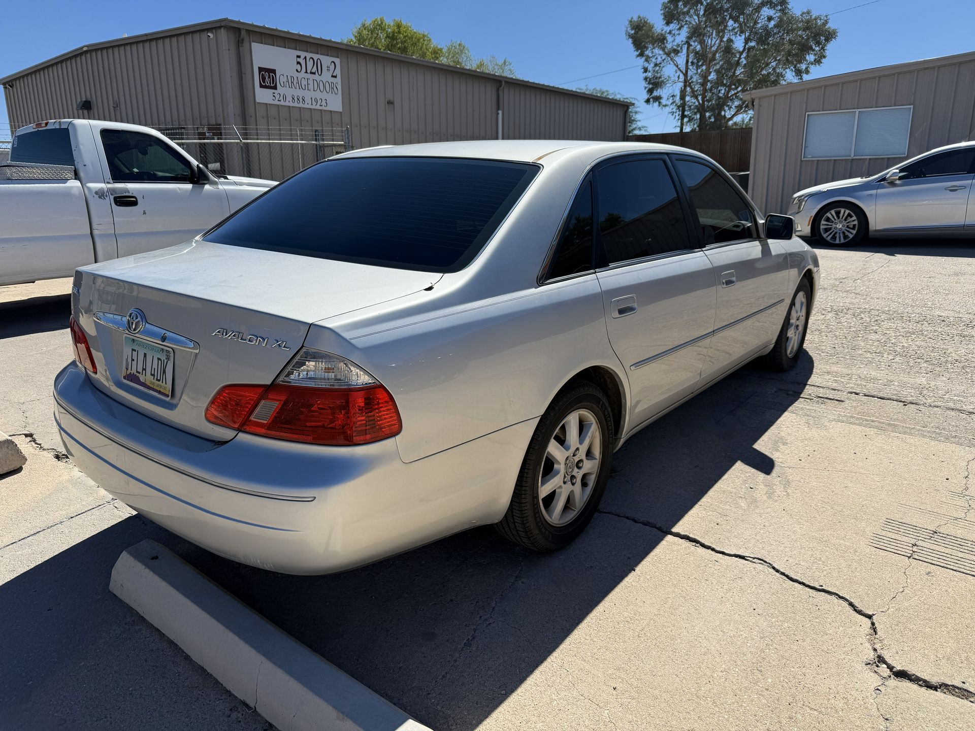 Silver Toyota Avalon parked outside a building.