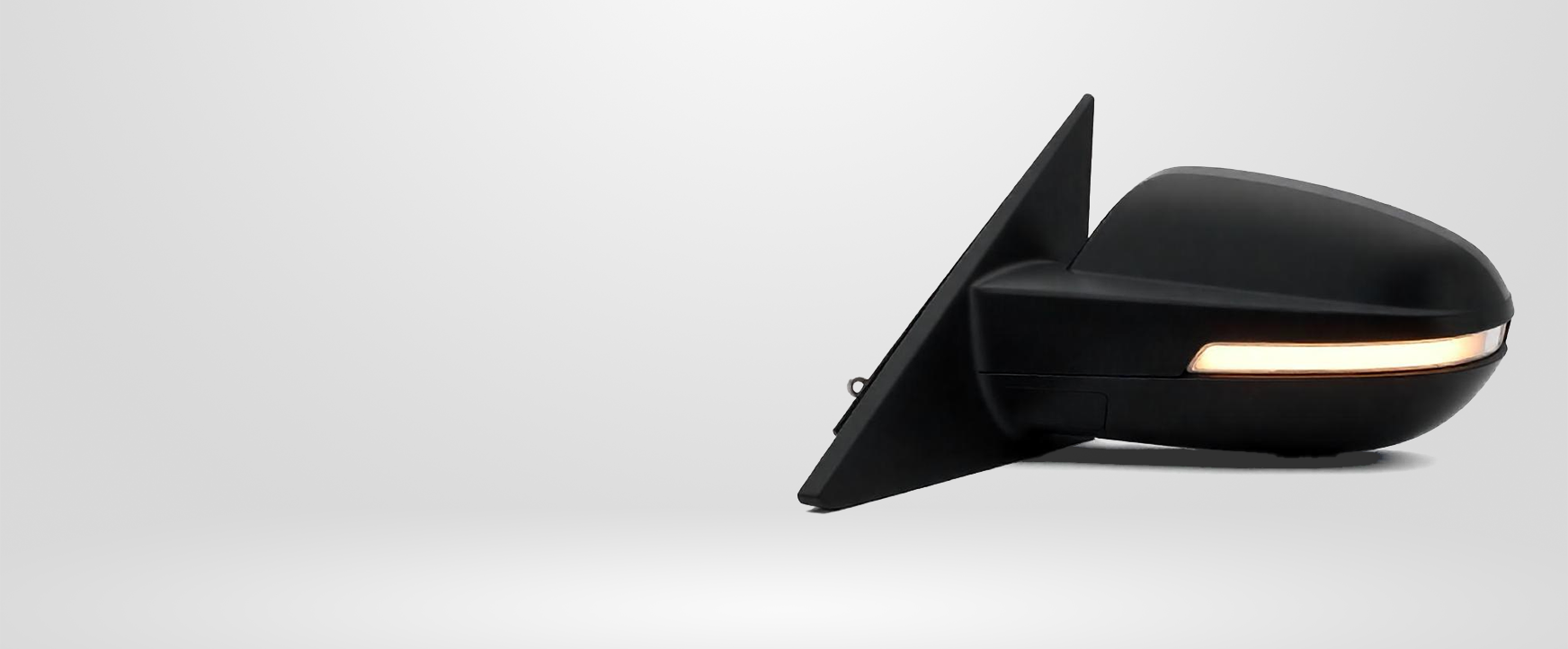 Black car side mirror with a yellow light on a white background.