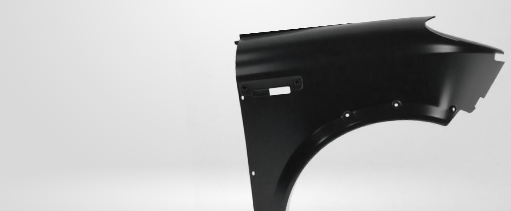 Black car fender against a white background.