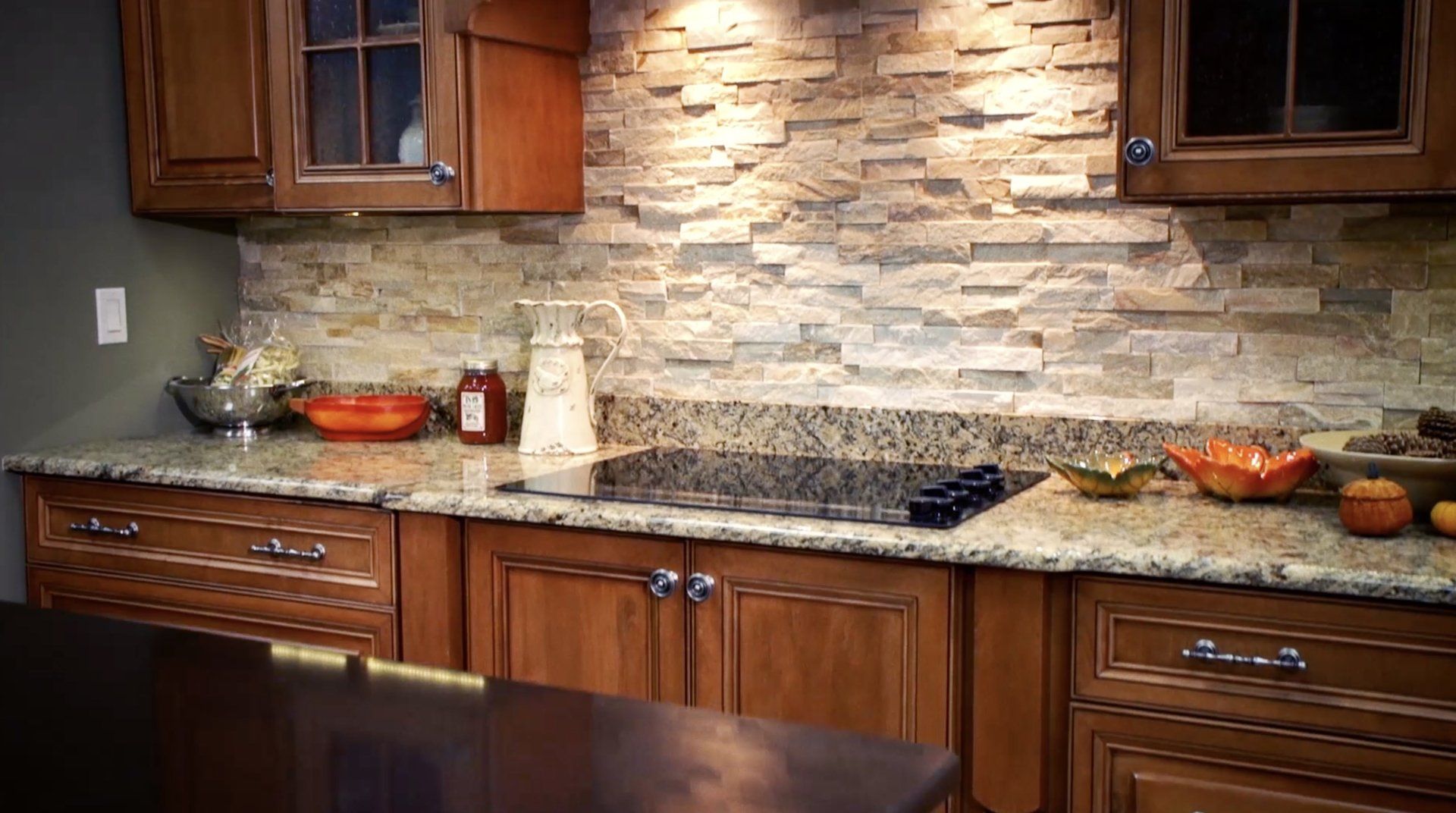 A kitchen with wooden cabinets and granite counter tops.