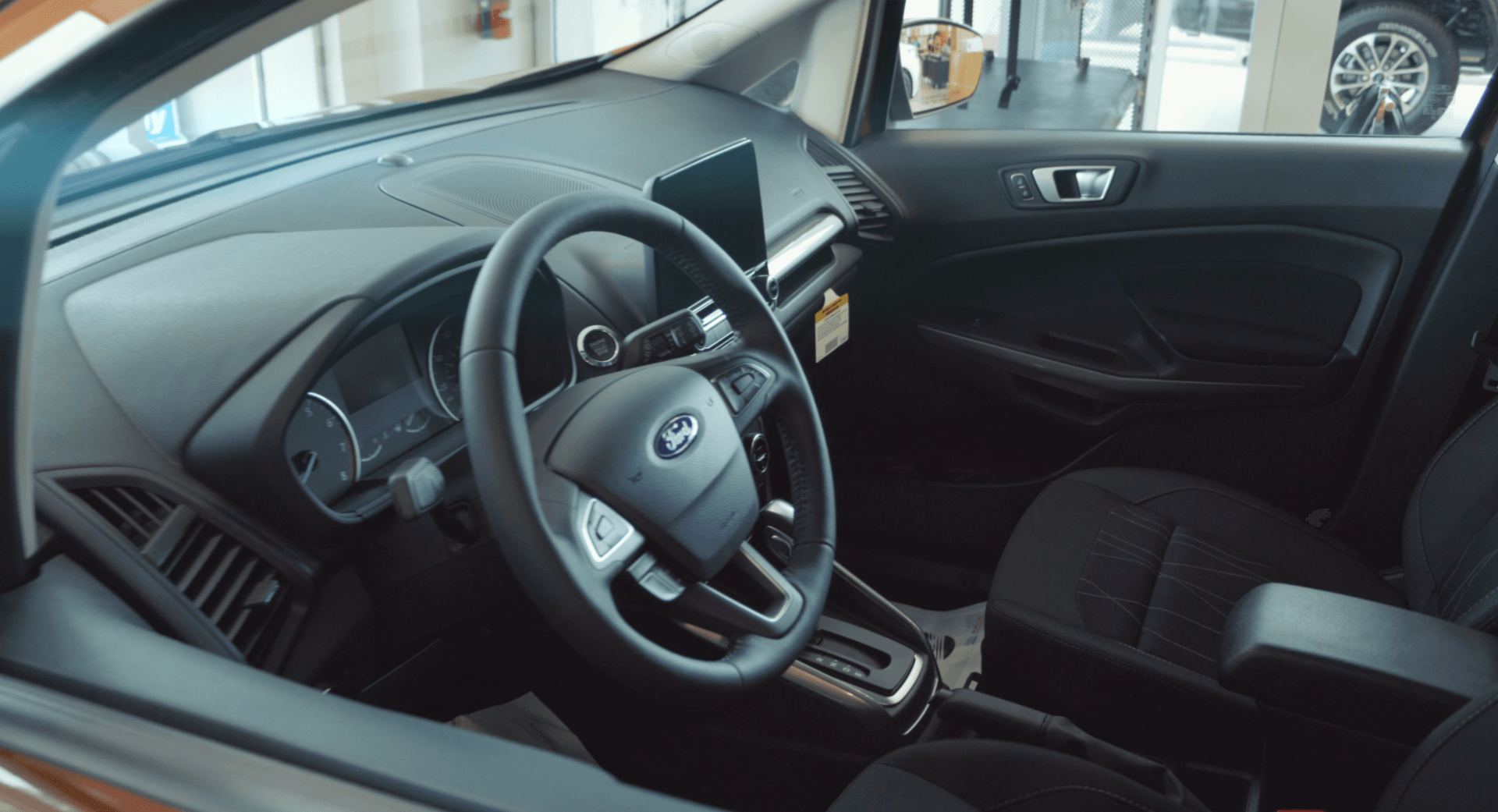 The interior of a ford car with a steering wheel and dashboard.