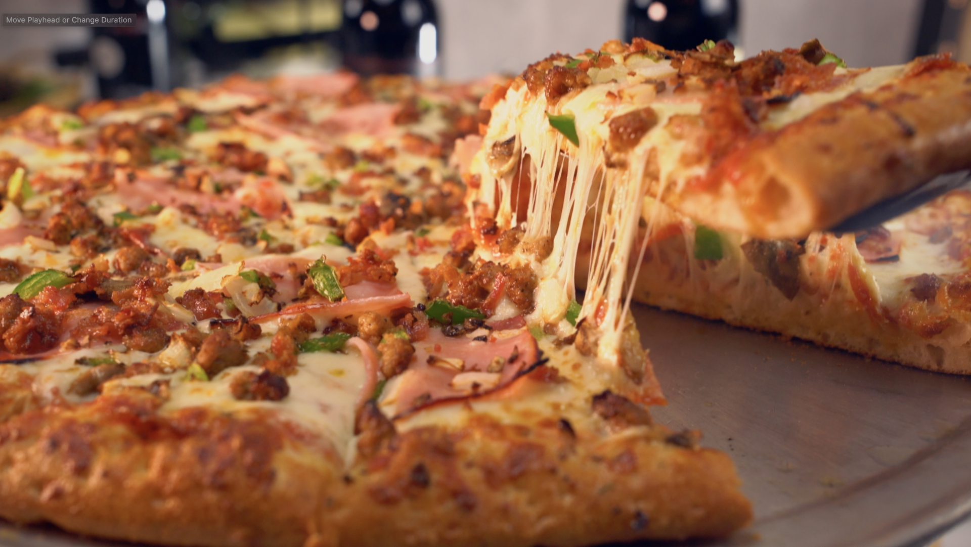 A pizza with a slice taken out of it on a plate.