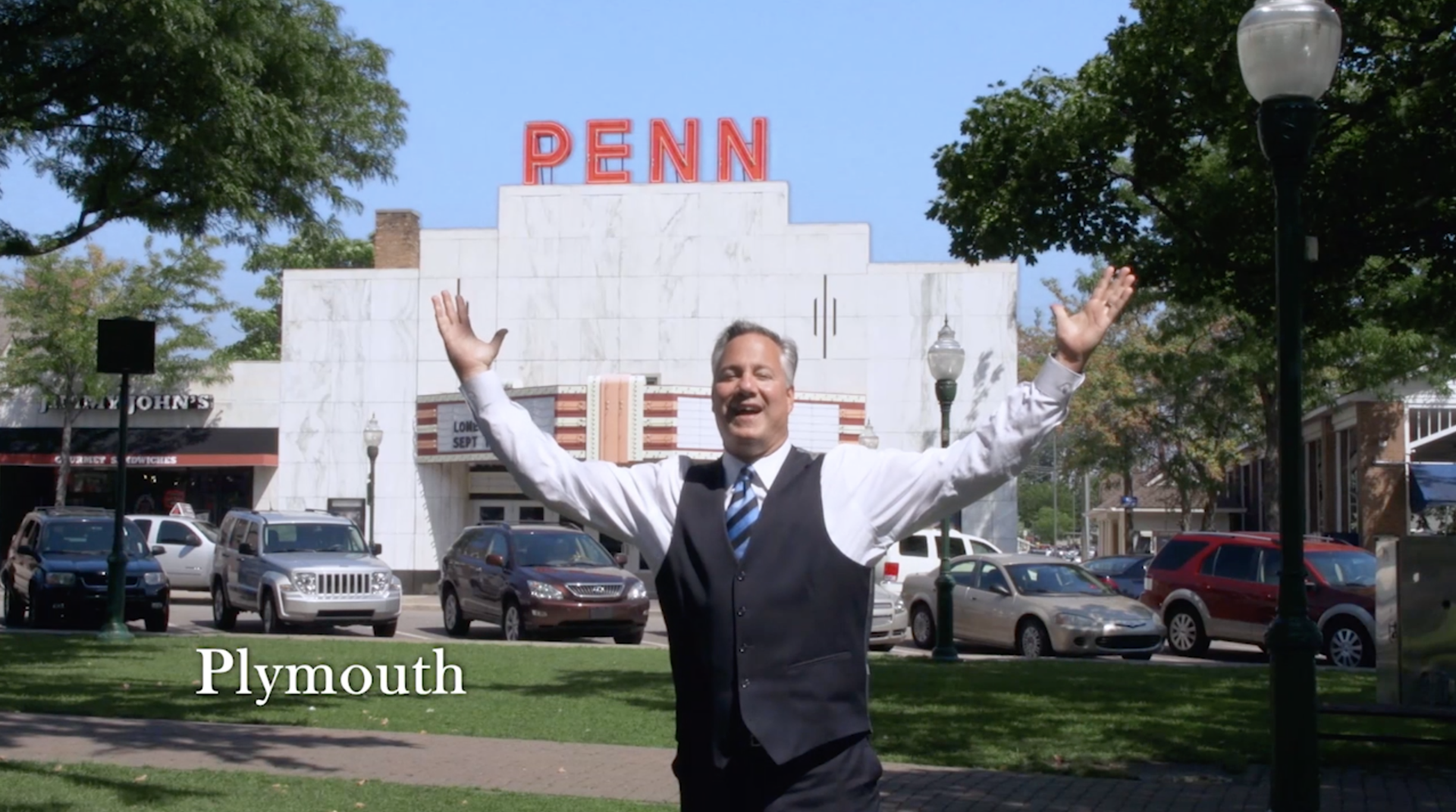 Harry Glans and tie is standing in front of a penn building in plymouth.