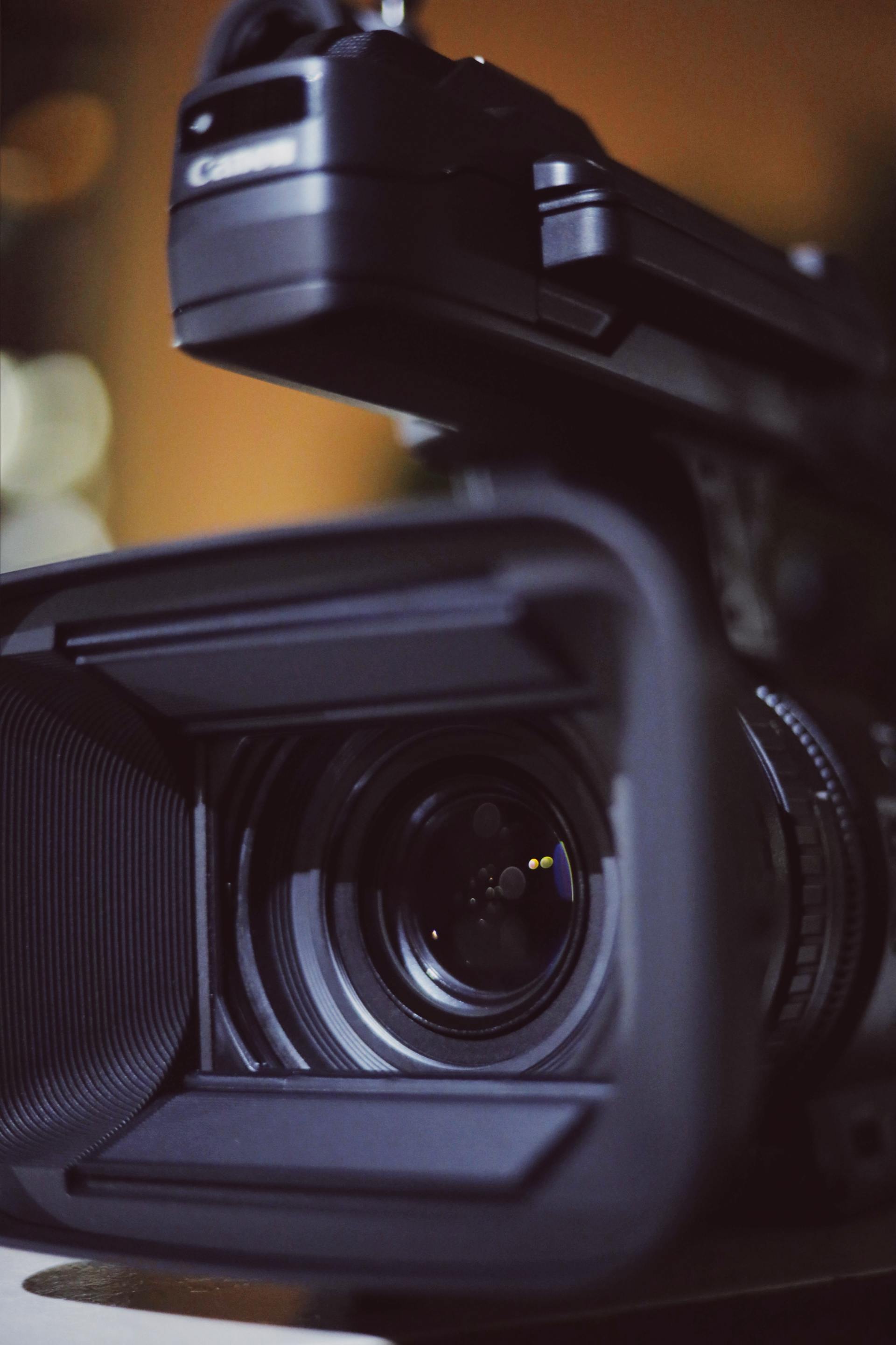 A canon video camera is sitting on a table