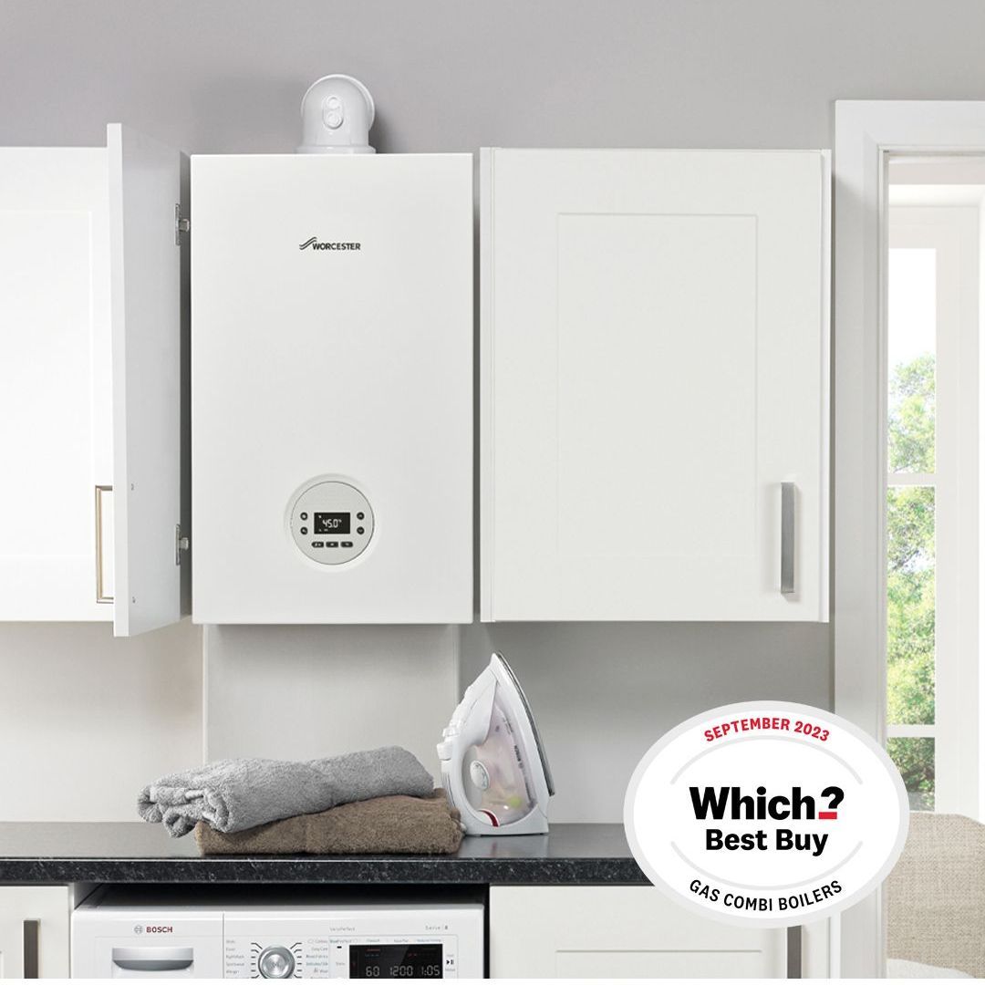 A boiler is mounted to the wall above a kitchen counter.