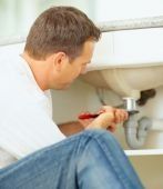 plumber fixing a clogged sink