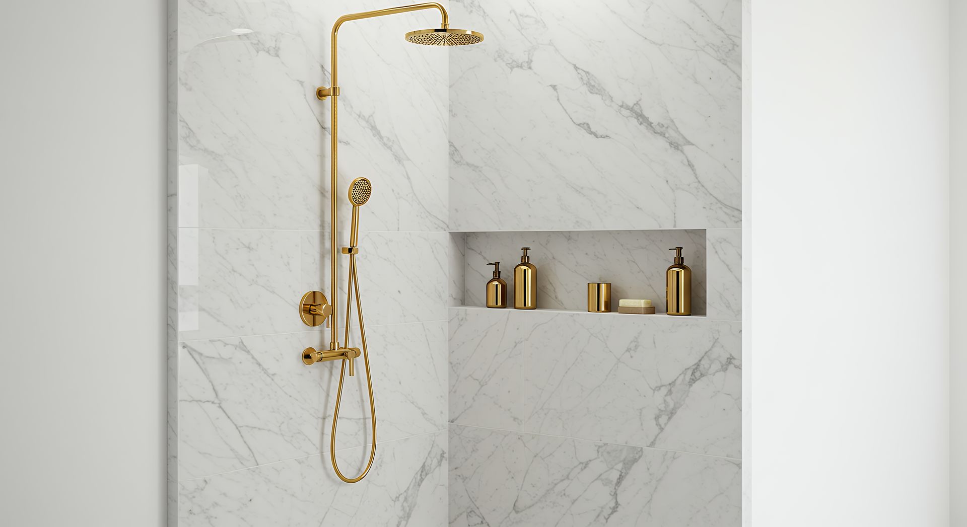 Gold shower fixture with handheld sprayer in a marble-tiled bathroom alcove with gold bottles