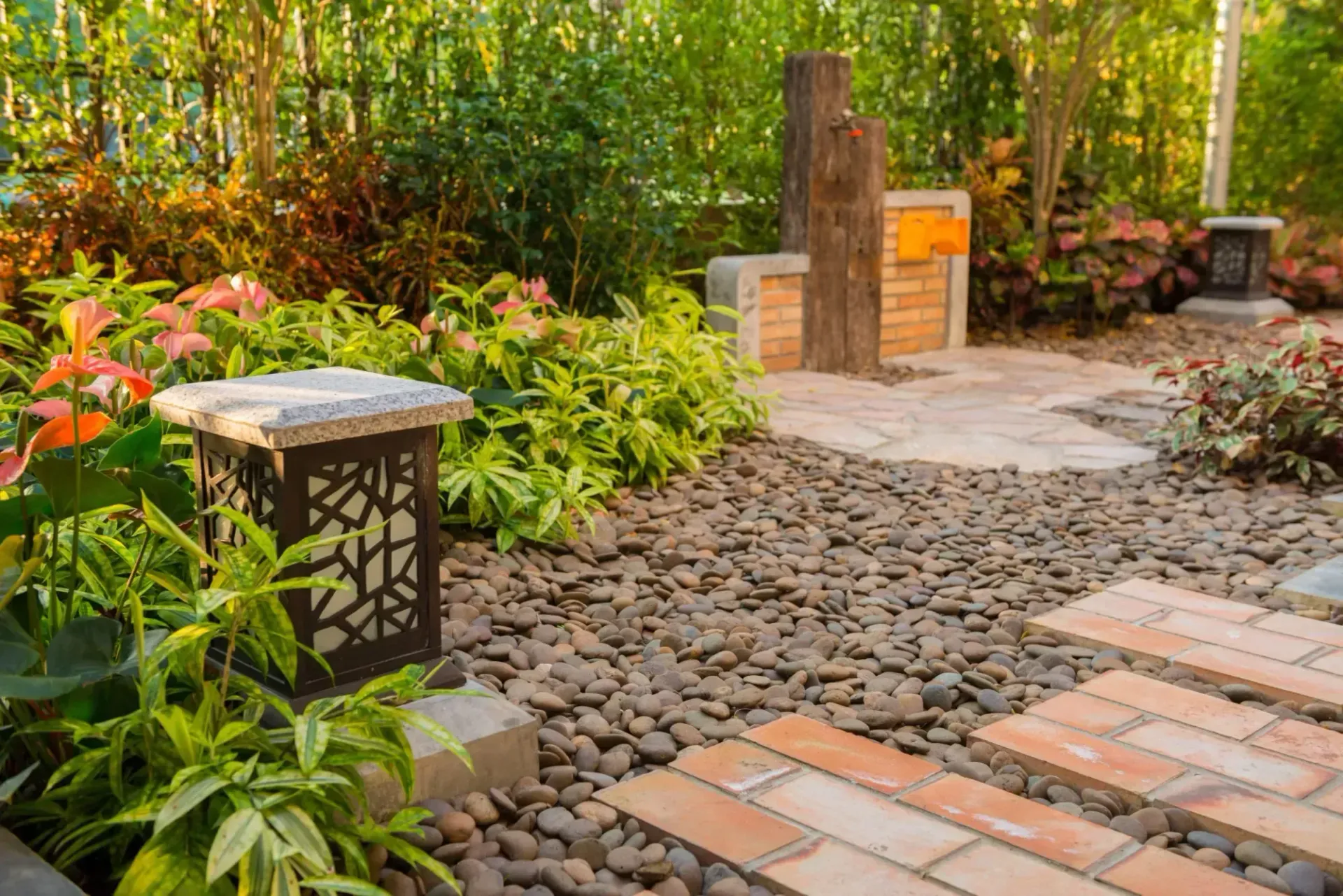 Garden pathway with brick steps, gravel, and diverse lush greenery. Garden pathway with brick steps, gravel, and diverse lush greenery.