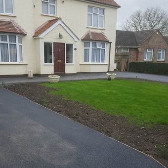 lawn area next to tarmacadam surface