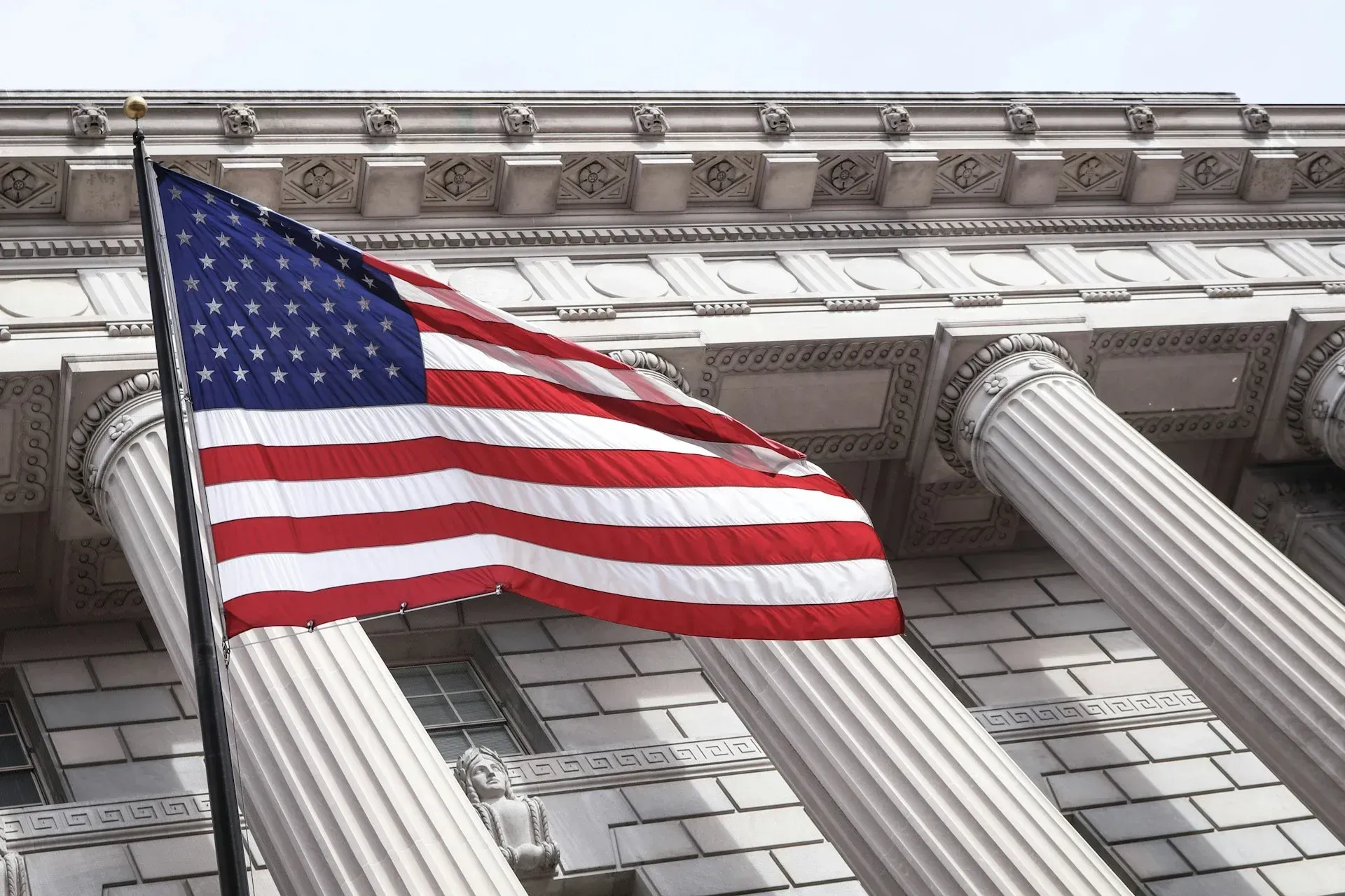 An american flag is flying in front of a building