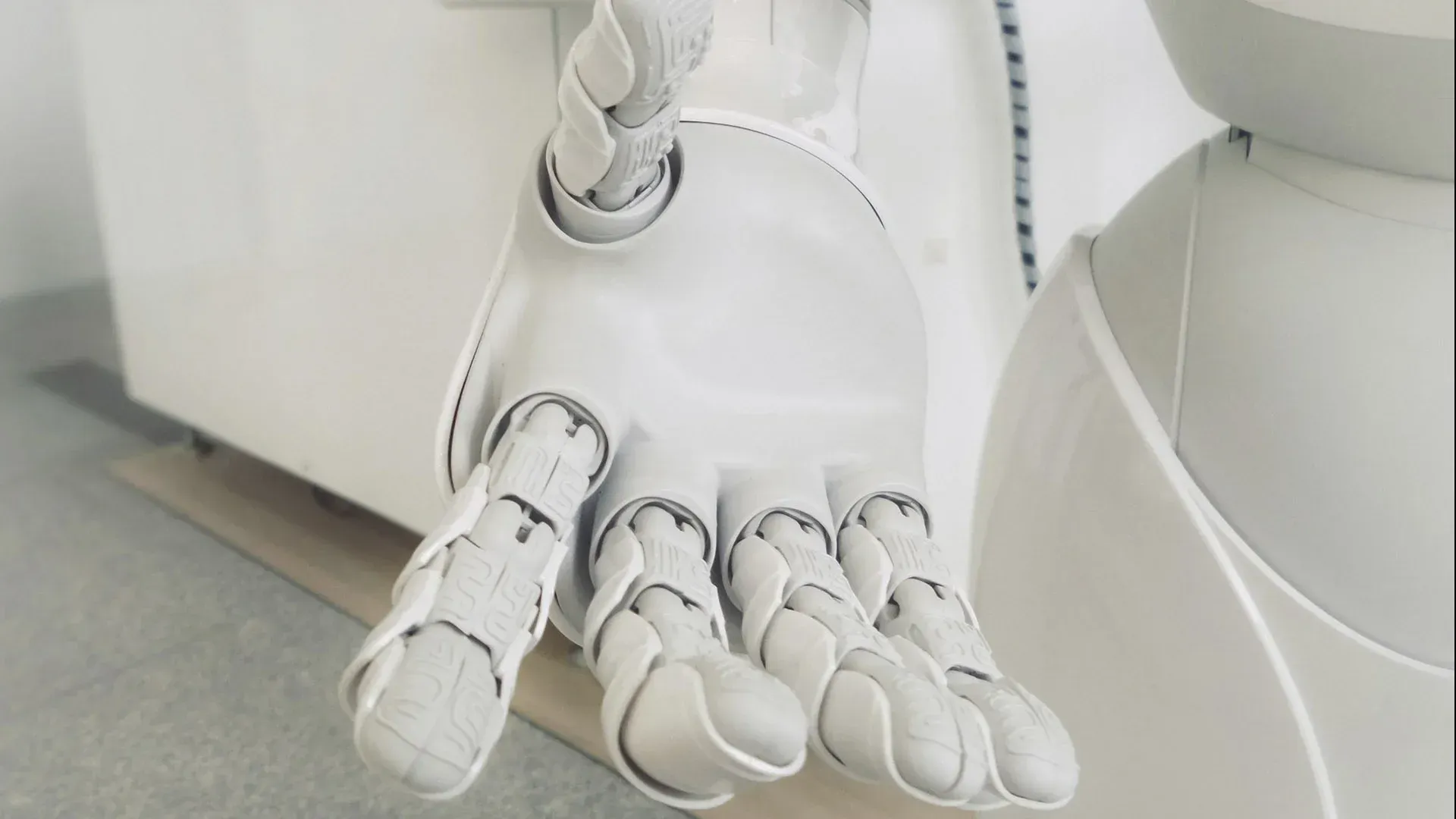 A white robotic hand in a stretched out position
