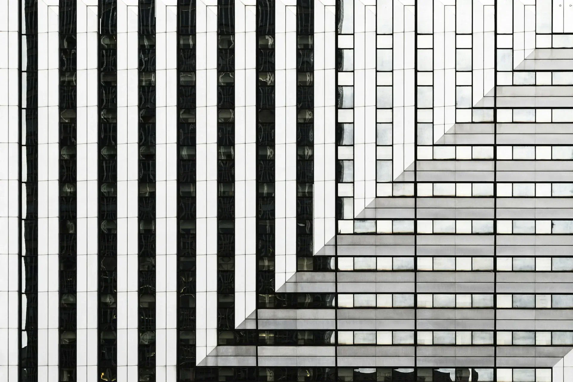 A black and white photo of a building with a geometric pattern.