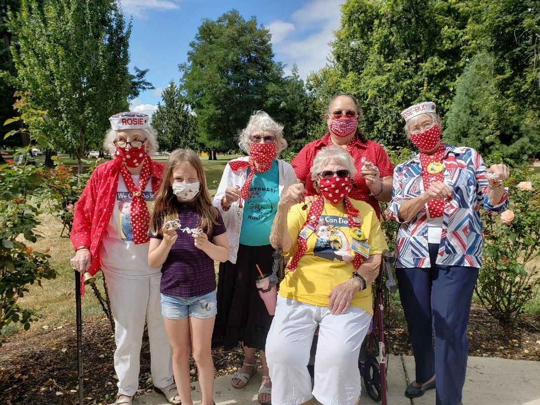 A group of people wearing face masks are posing for a picture.