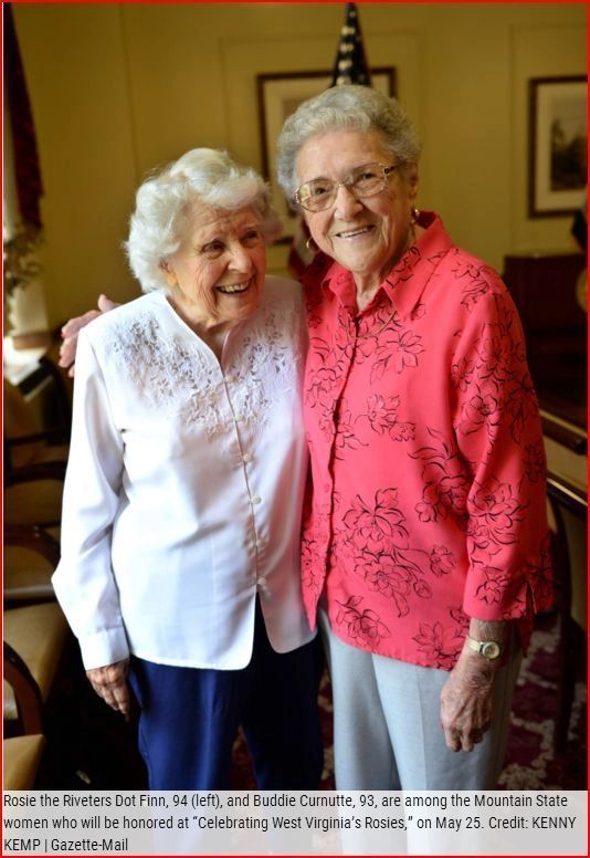 Two older women are posing for a picture and one is wearing a red shirt