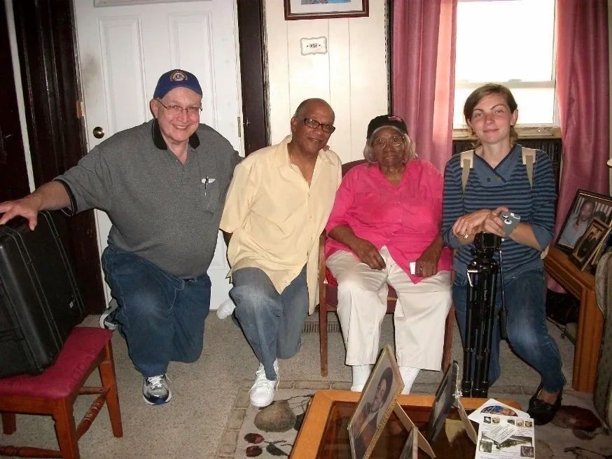 A group of people posing for a picture in a living room