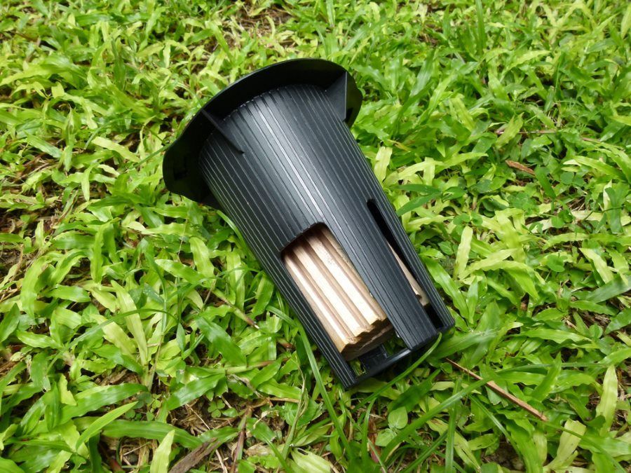 A Black Object is Sitting on Top of a Lush Green Field — Superior Termite & Pest Control in Nambour, QLD