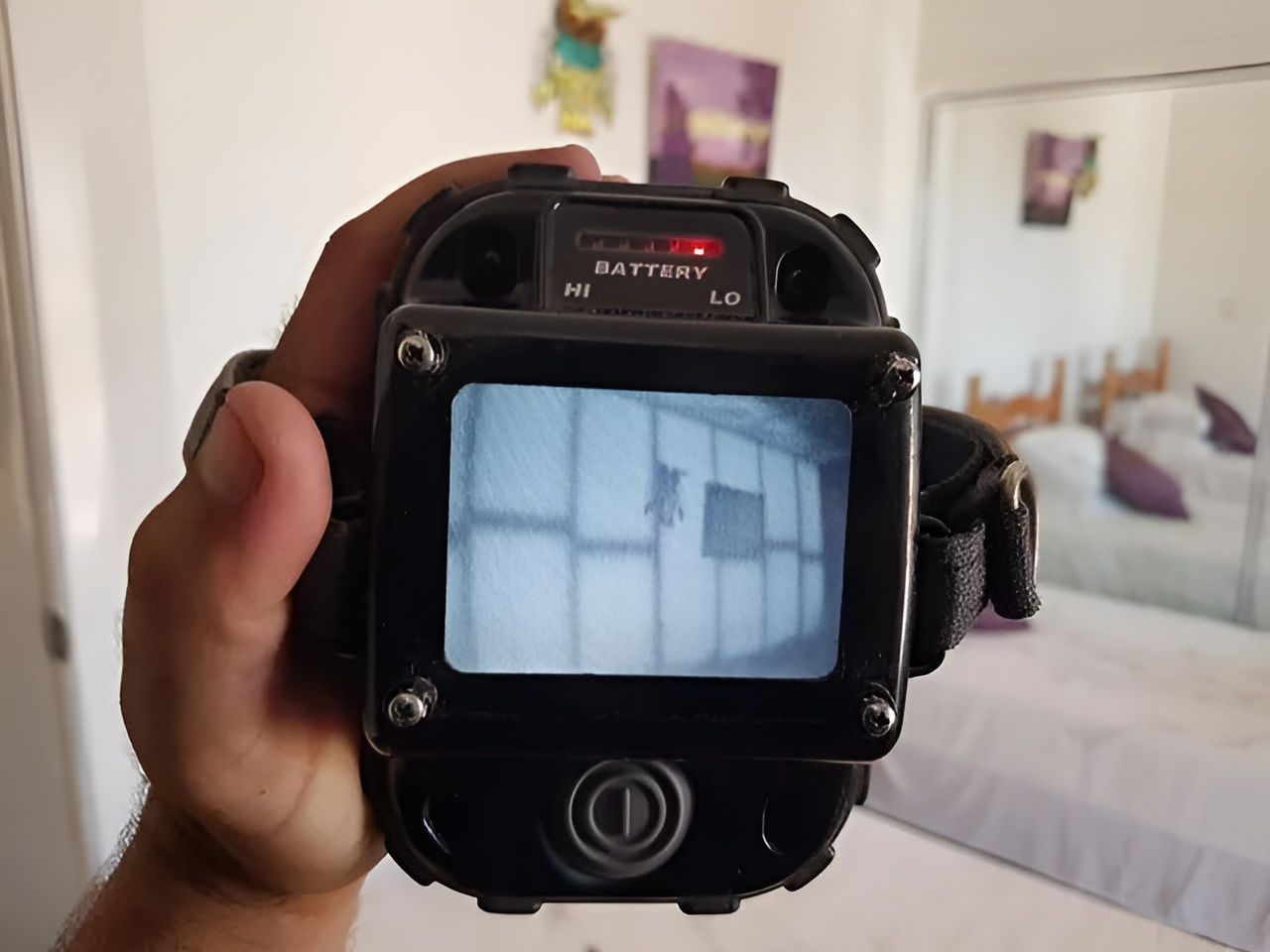 A person is holding a camera that says battery on it