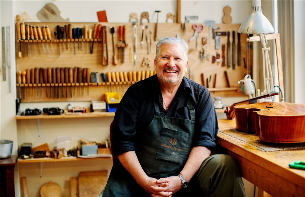A close up of a violin with a black background