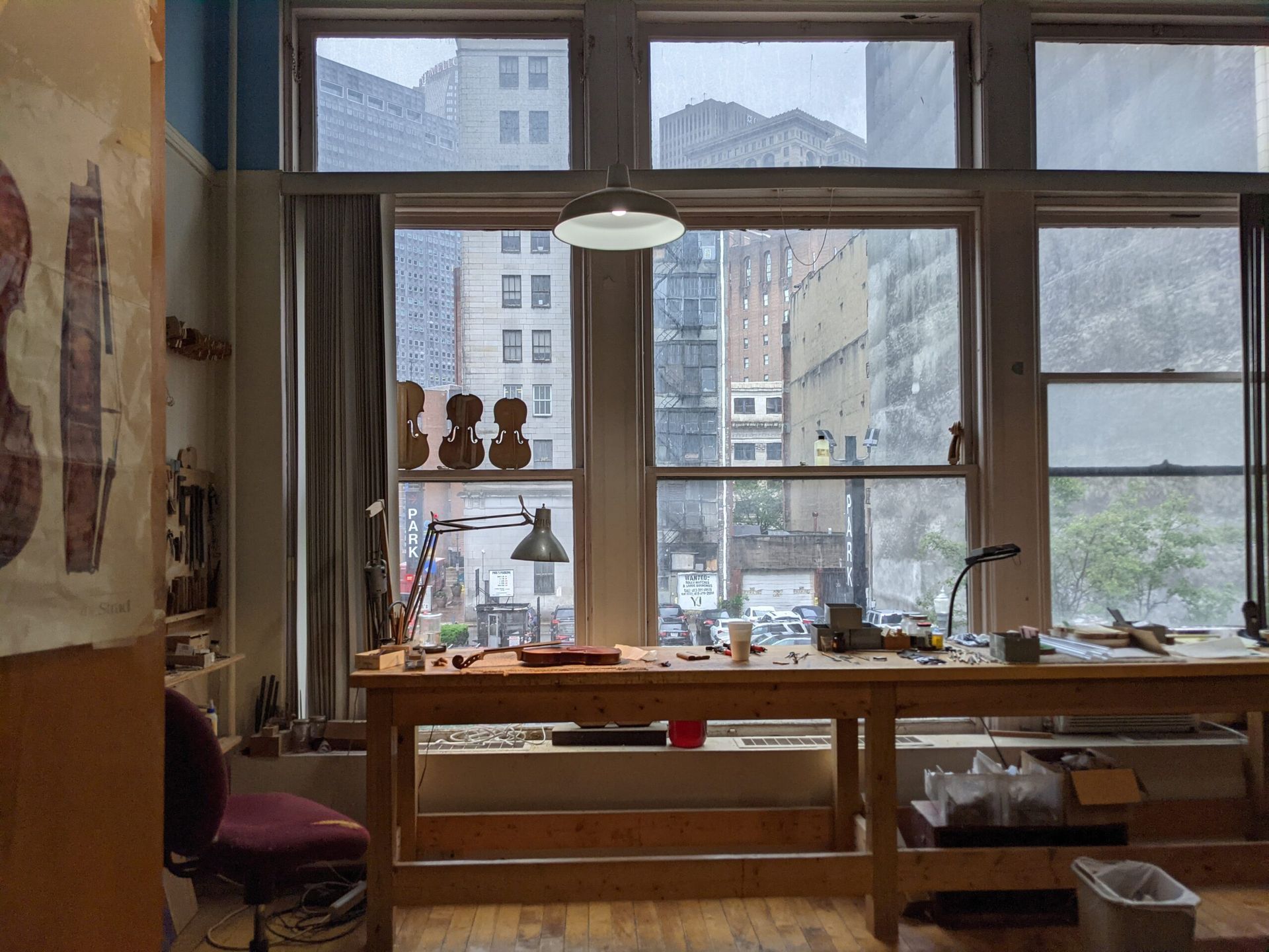 A violin is sitting on a wooden table.