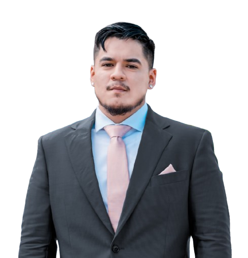 A man in a suit and tie is standing in front of a white background