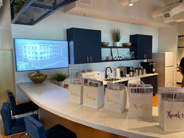 A kitchen with a lot of bags on the counter that say thank you