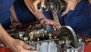Two men holding the transfer case — auto repair in West Valley City, UT