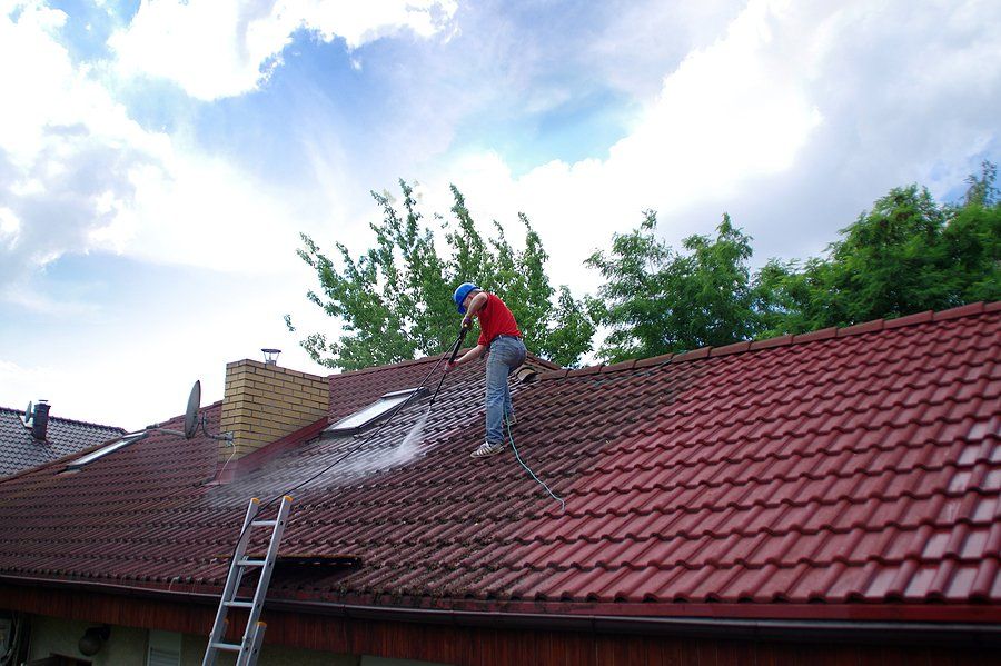 man in the roof spraying the roof
