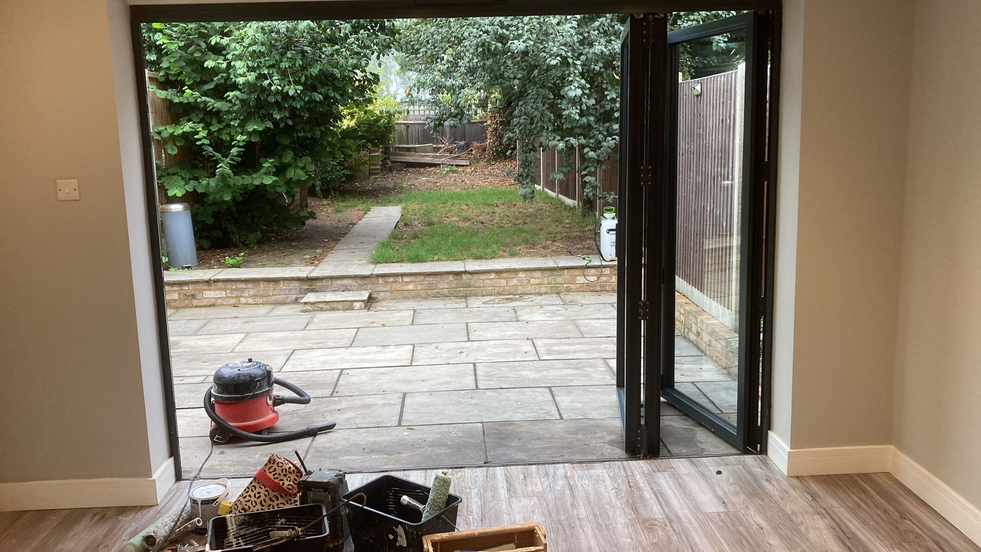 A room with a sliding glass door leading to a patio.