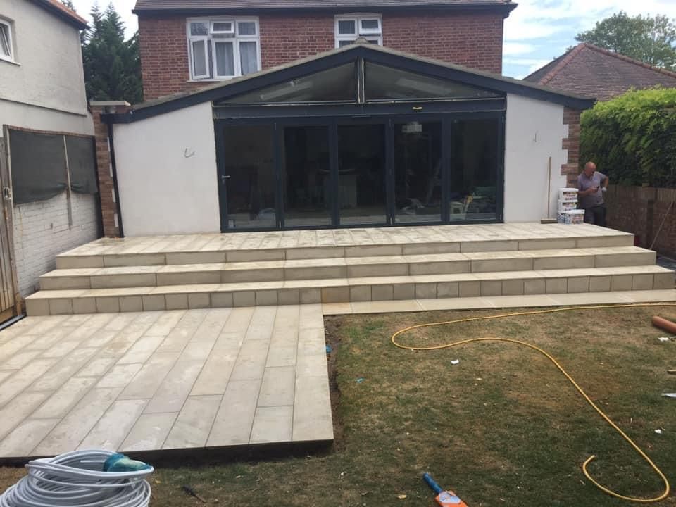 A house with a patio and stairs in front of it