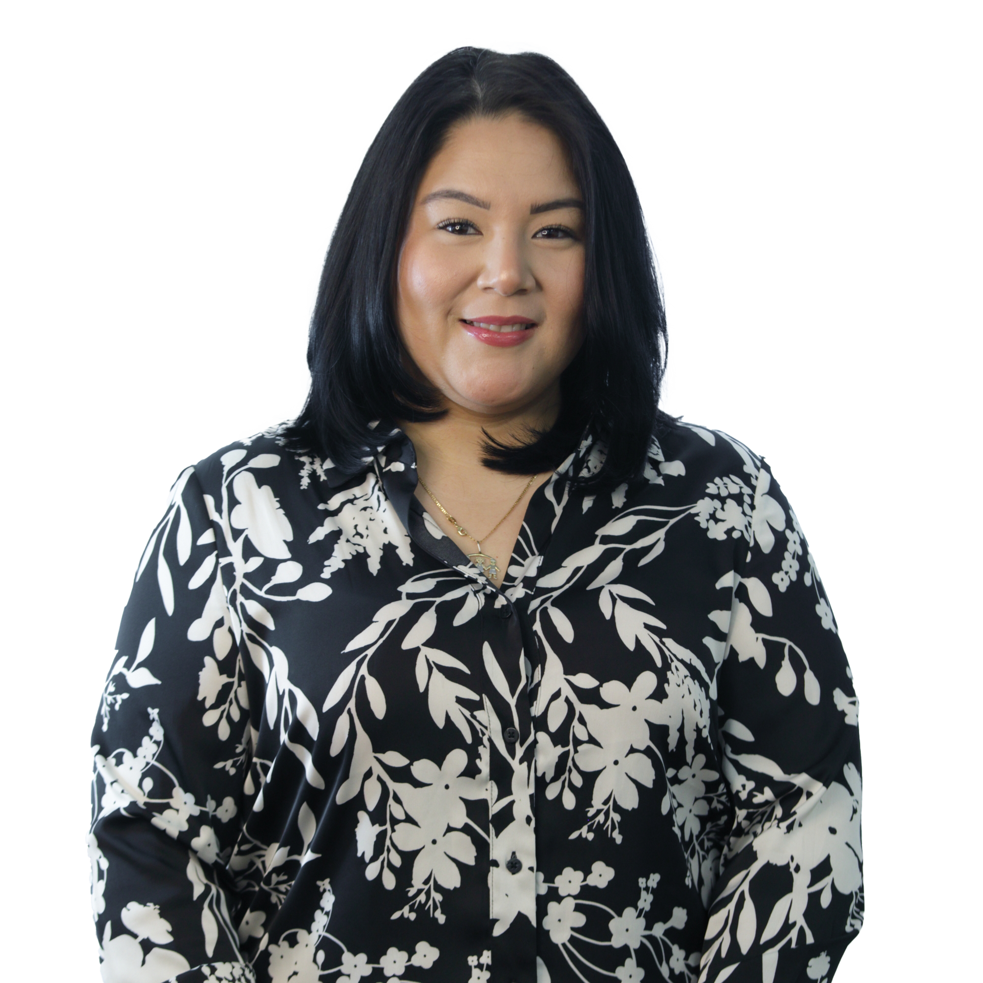 Woman with black hair, wearing a black and white floral blouse, smiling.