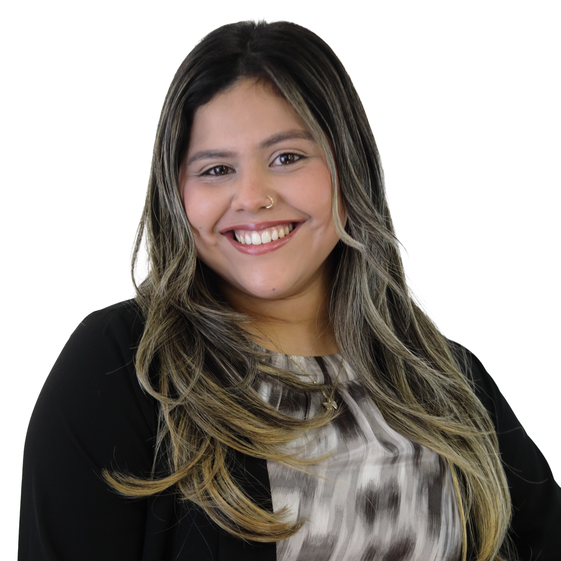 Woman smiling, long wavy hair, black blazer over a gray and white patterned top against white backdrop.