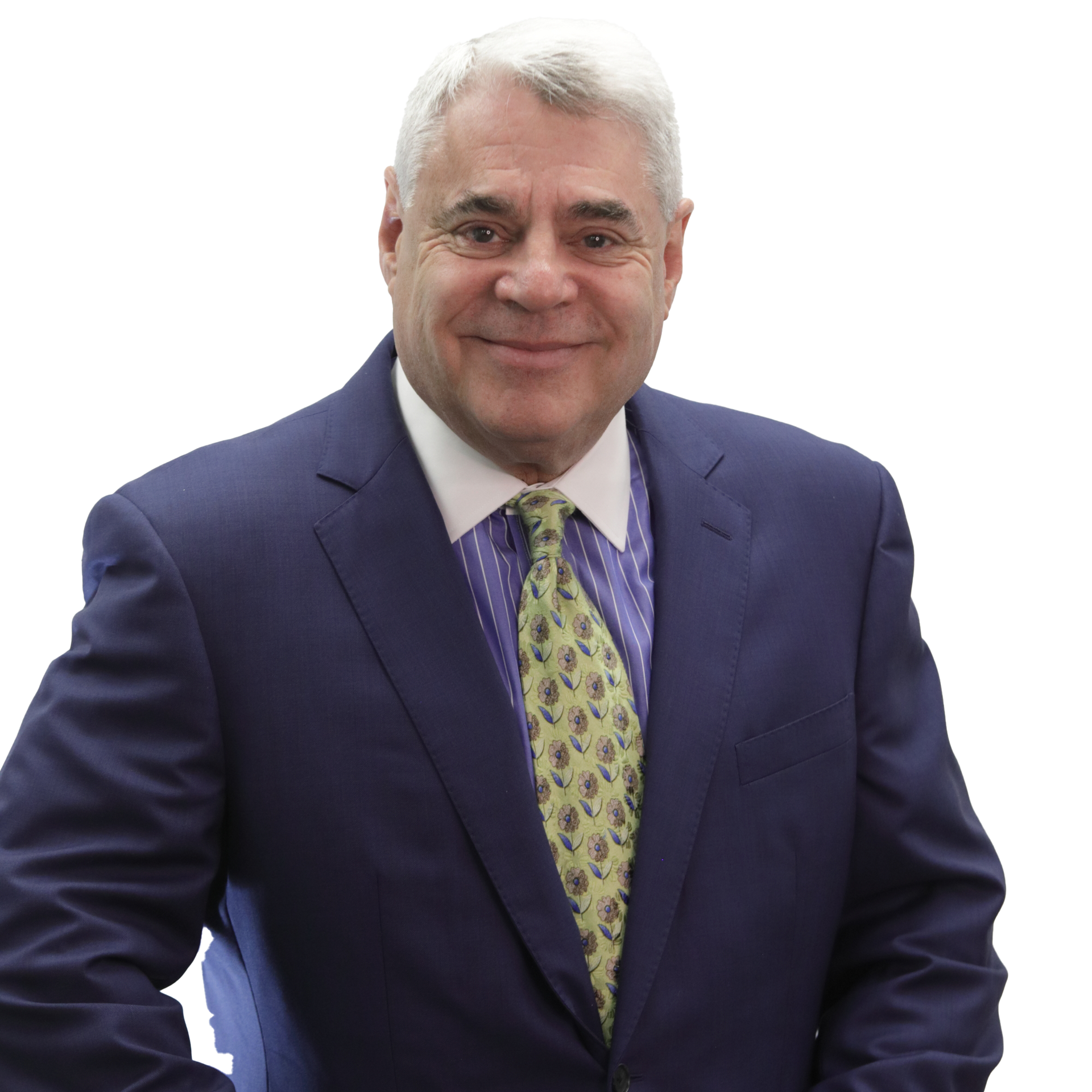 Smiling man in suit and tie, against a dark gray backdrop.