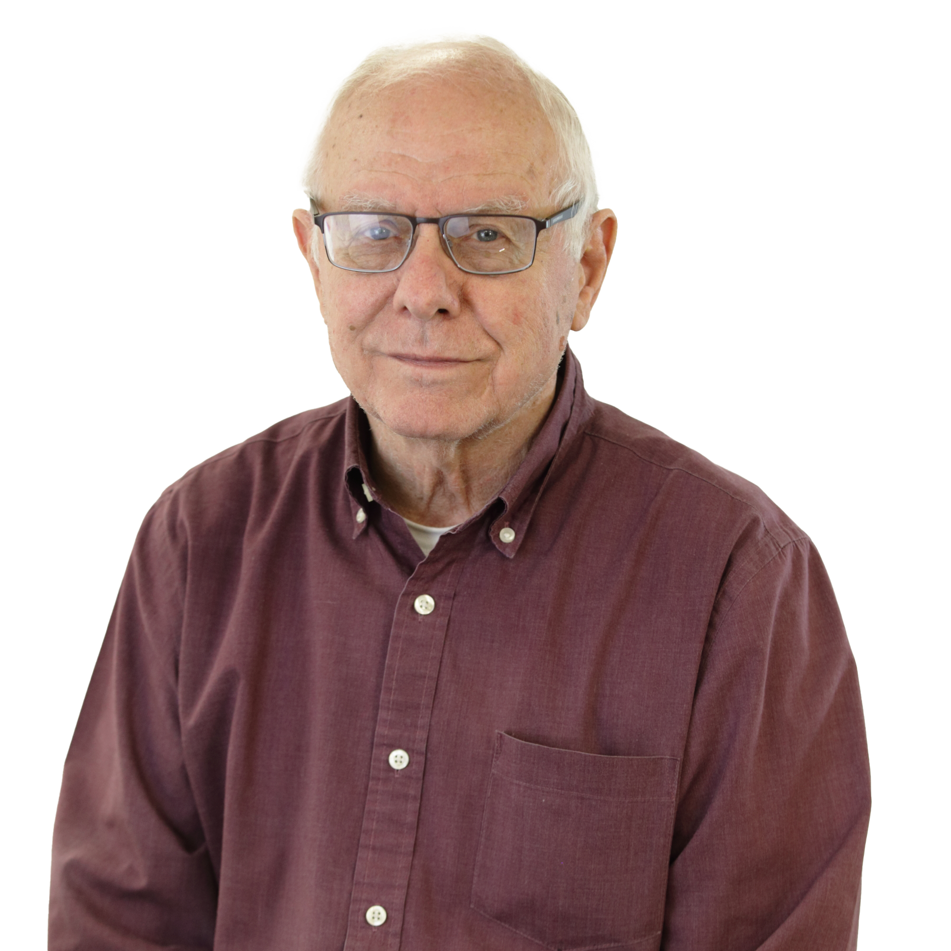 Man wearing glasses and a maroon button-down shirt. Poses indoors, against a white background.
