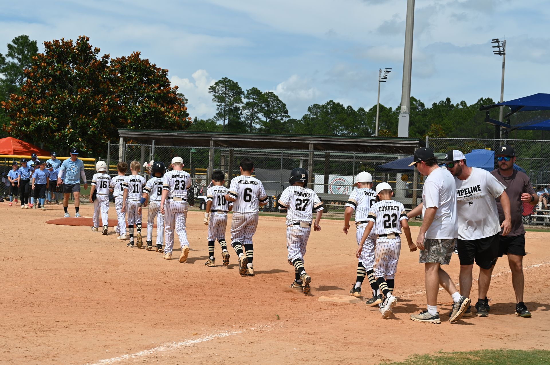 Prime Athletics players taking the field with coaches