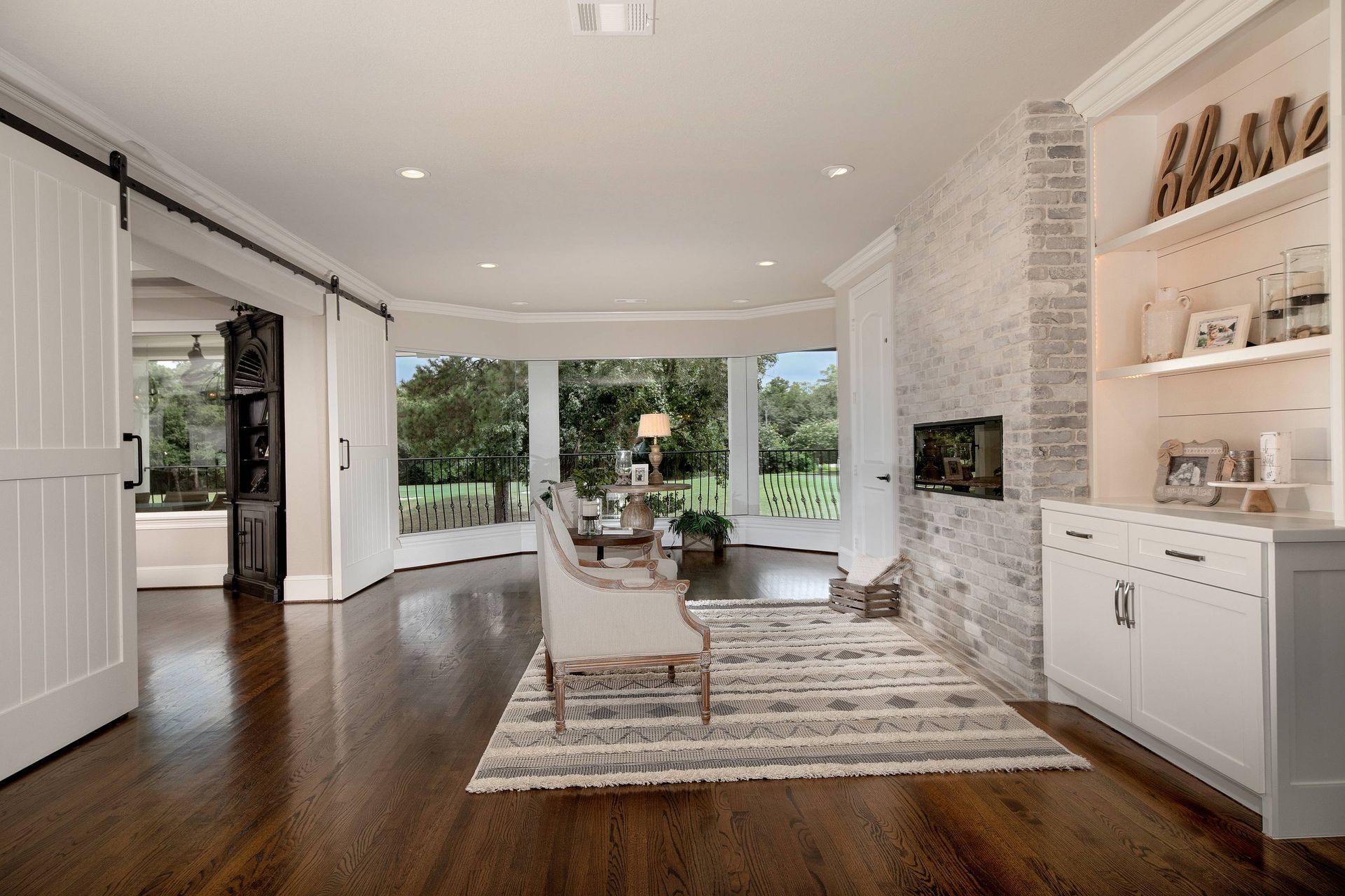 A living room with hardwood floors and a fireplace