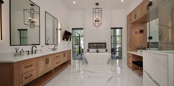 A large bathroom with a bathtub , sinks , mirrors and a walk in shower.