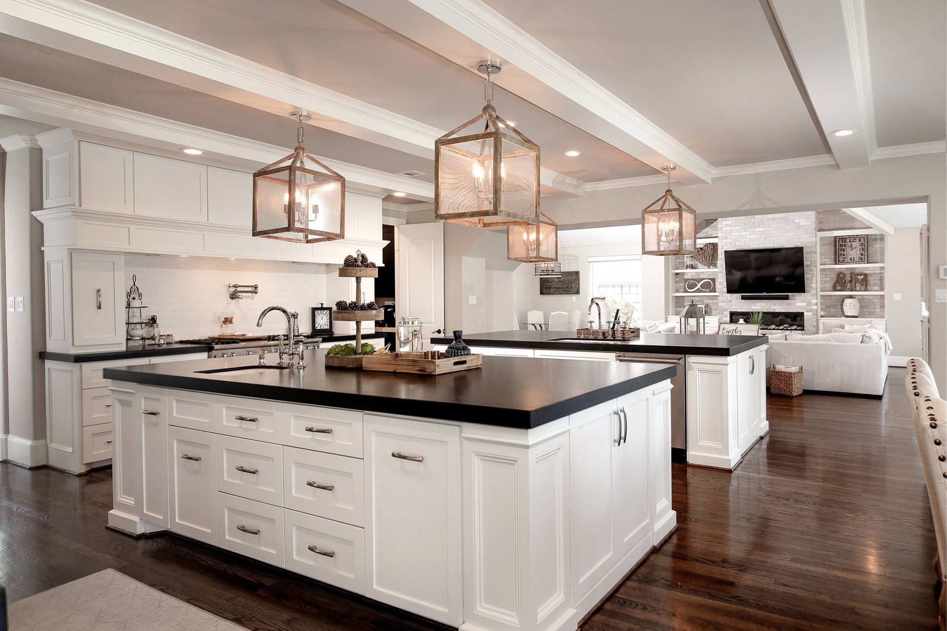 A kitchen with white cabinets and a large island in the middle.