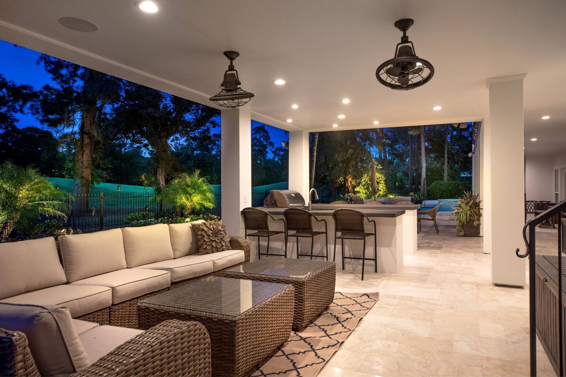 A living room with a lot of furniture and a ceiling fan.