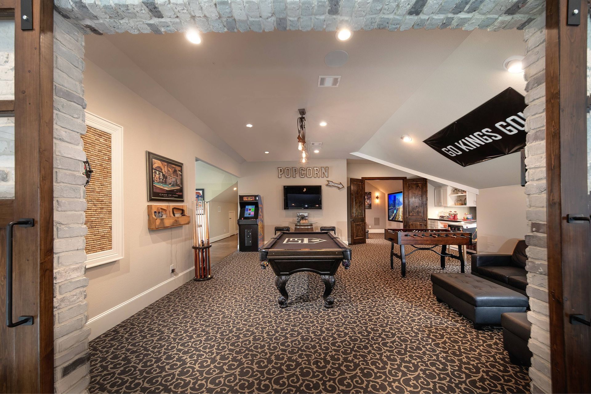 There is a pool table in the middle of the room.