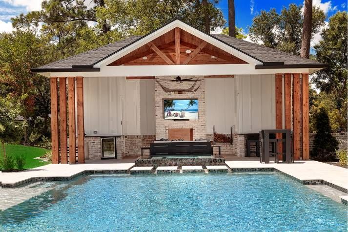 A house with a swimming pool in front of it