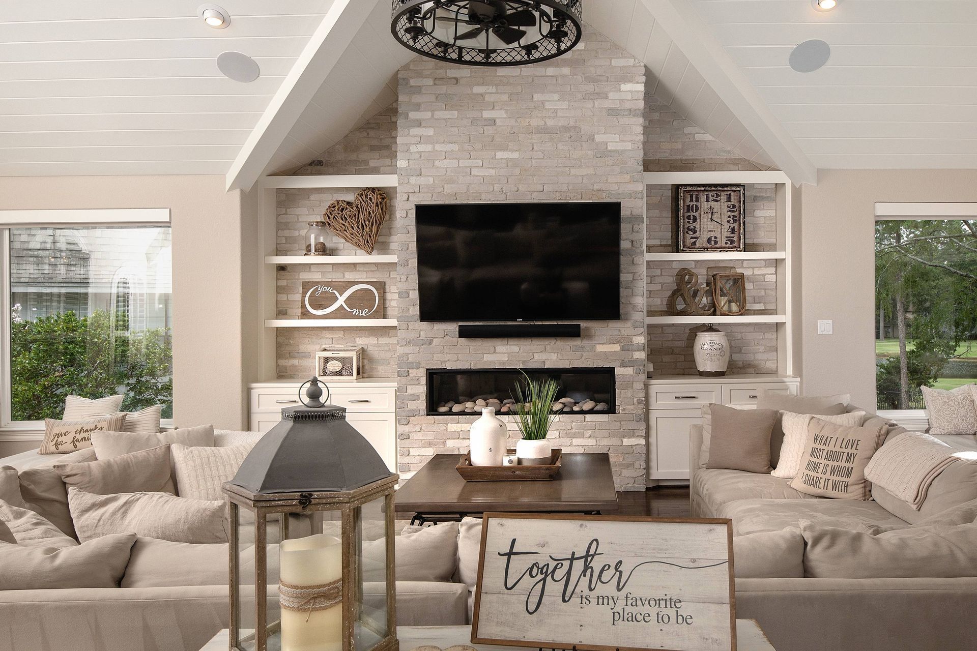 A living room with a fireplace and a flat screen tv.