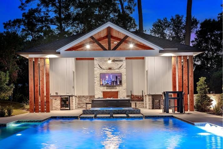 A house with a large swimming pool in front of it.
