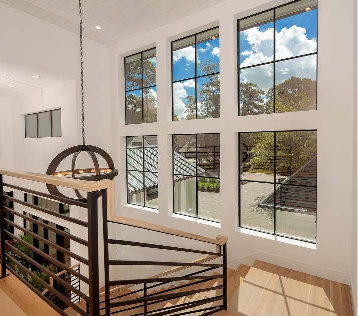 A staircase with a railing and lots of windows