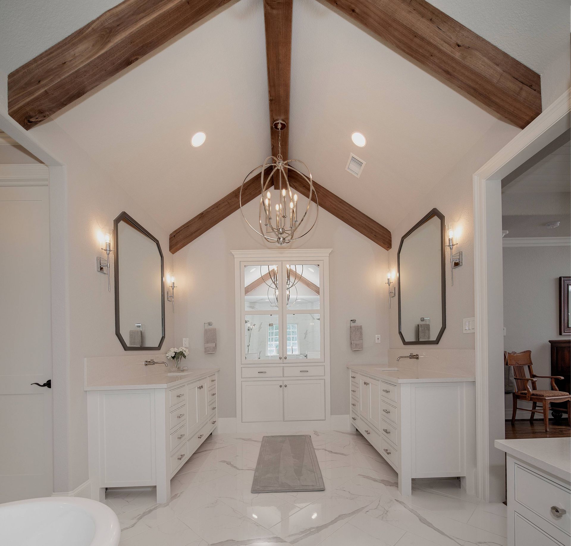 A bathroom with a vaulted ceiling and wooden beams