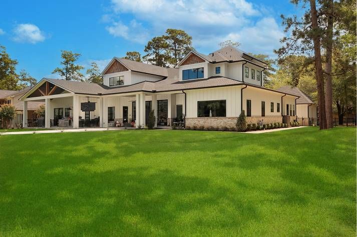 A large house with a lush green lawn in front of it.